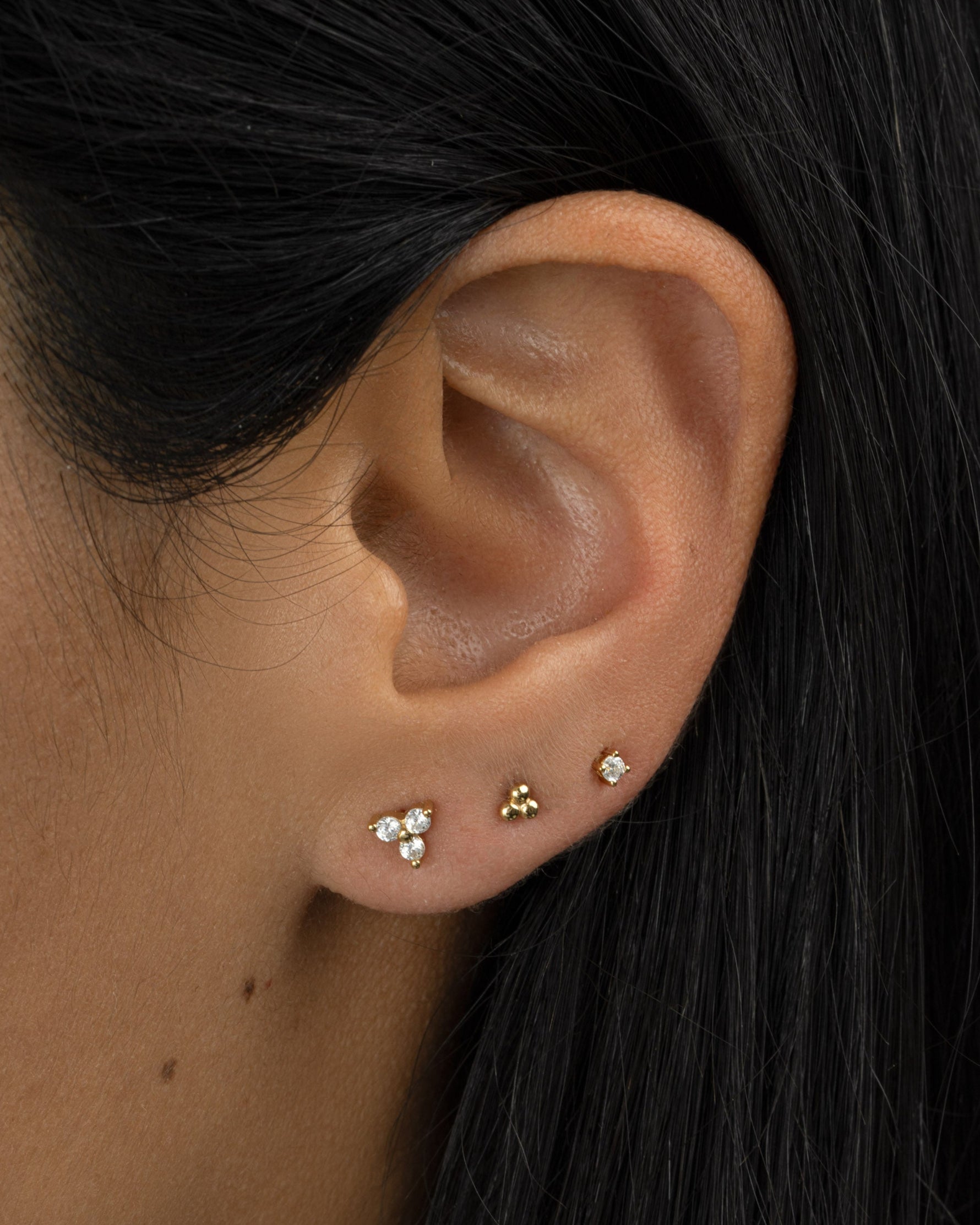 Gold 3-ball stud earrings by Sami Jewels worn in second ear piercing, showcasing minimalist jewelry style.