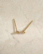 Gold 3-ball stud earrings by Sami Jewels, close-up profile view showing their simple, elegant design.