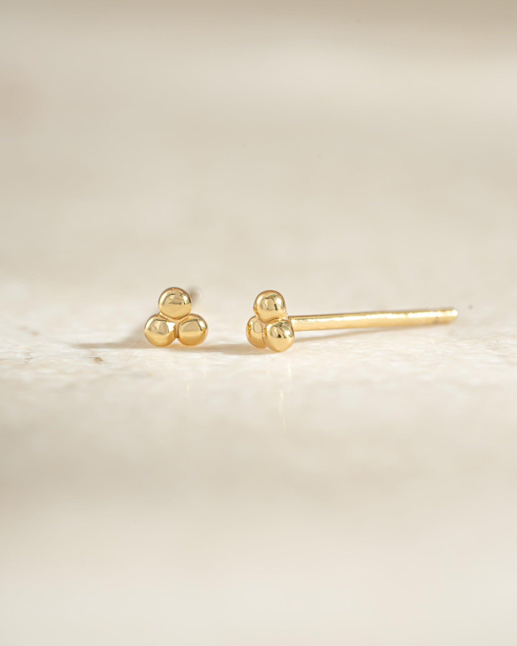 Gold 3-ball stud earrings by Sami Jewels, side view showing small spherical studs for elegant everyday wear.