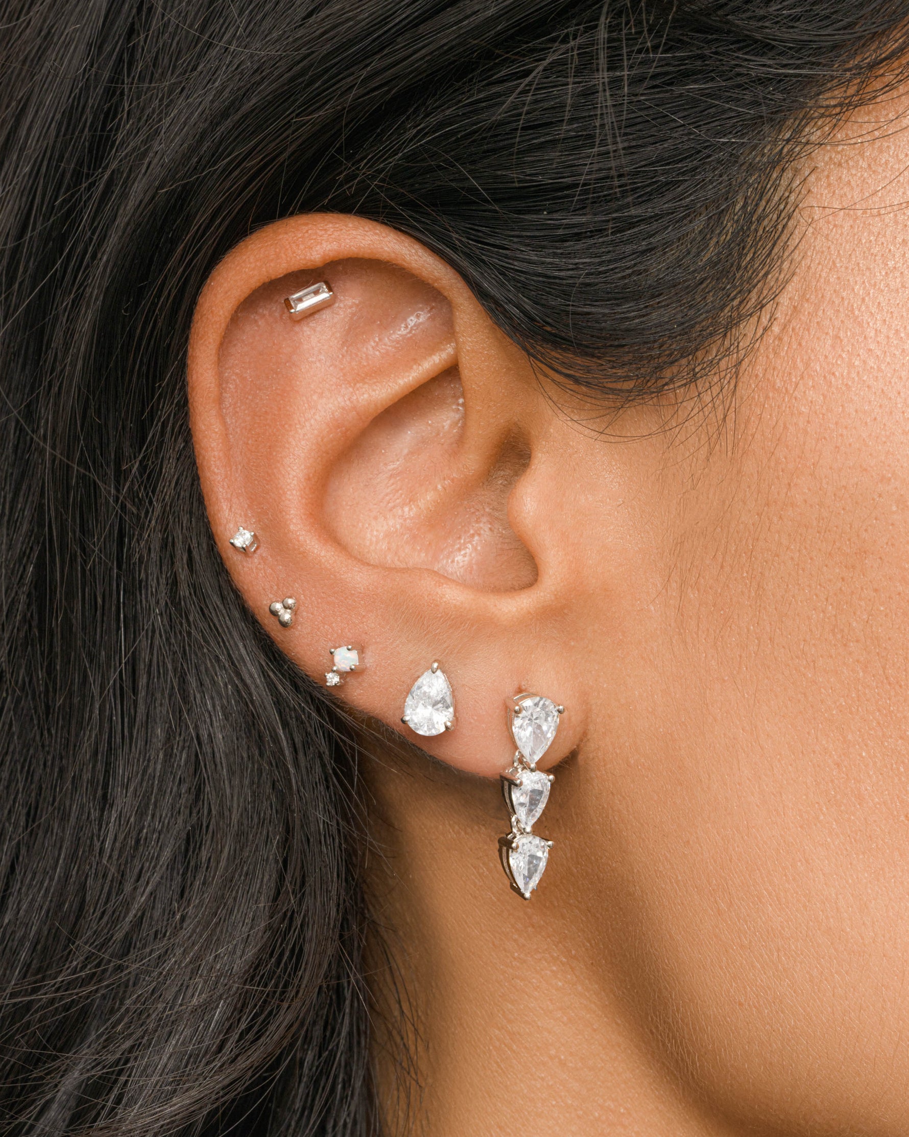 Sterling silver 3-ball stud earrings by Sami Jewels worn on model, minimalist and stylish jewelry accessory.
