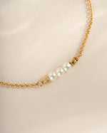 Elegant gold bracelet with three white pearls from Sami Jewels, showcasing a delicate and sophisticated jewelry piece.