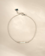 Close-up of a Sami Jewels sterling silver bracelet featuring three elegant white pearls, showcasing its delicate craftsmanship.