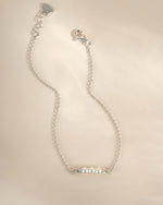 Sterling silver bracelet with three white pearls, stylish jewelry piece from Sami Jewels featuring elegant design.