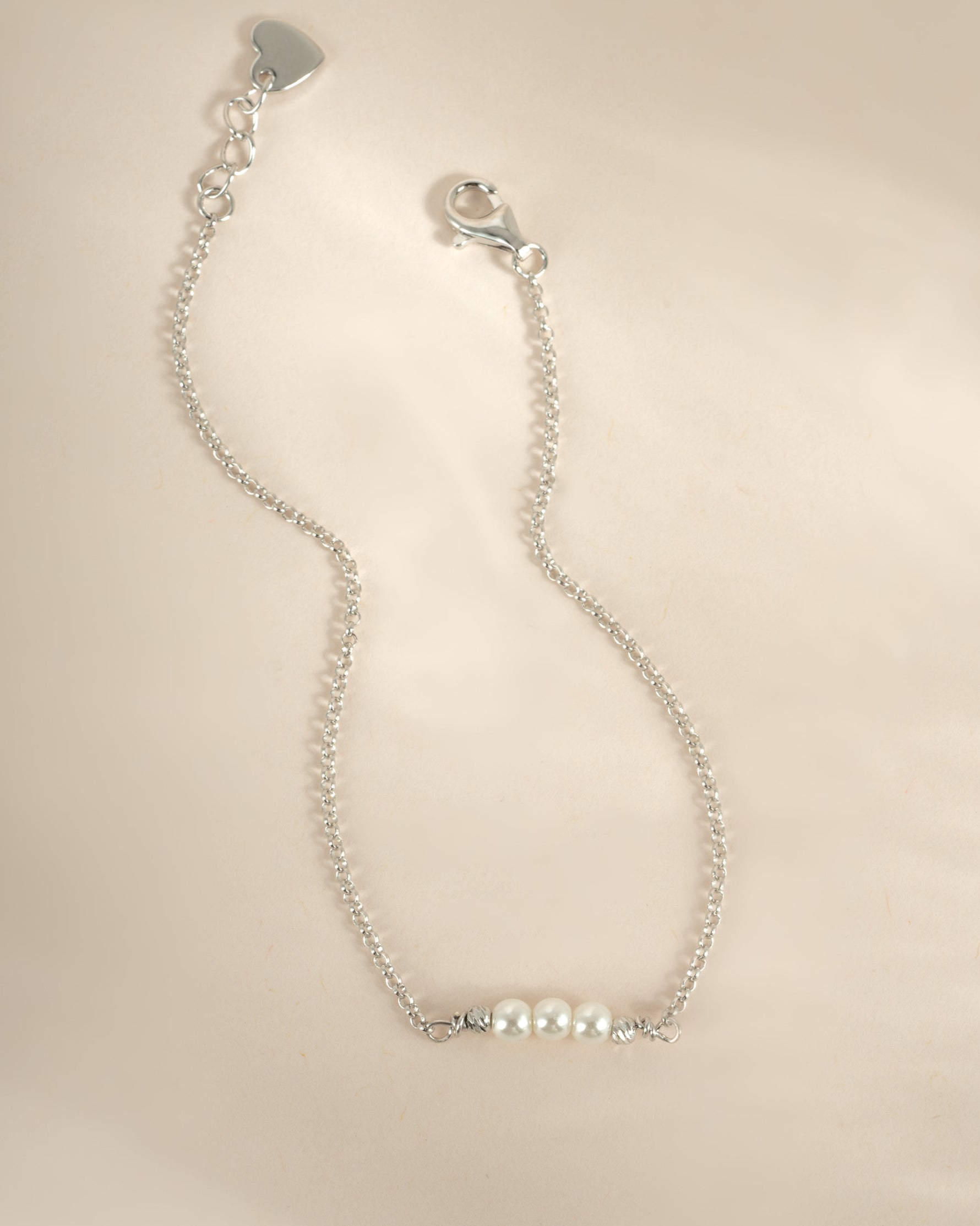 Sterling silver bracelet with three white pearls, stylish jewelry piece from Sami Jewels featuring elegant design.