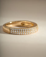 Close-up of a gold 3-row diamond ring by Sami Jewels, showcasing sparkling diamonds and intricate band design.