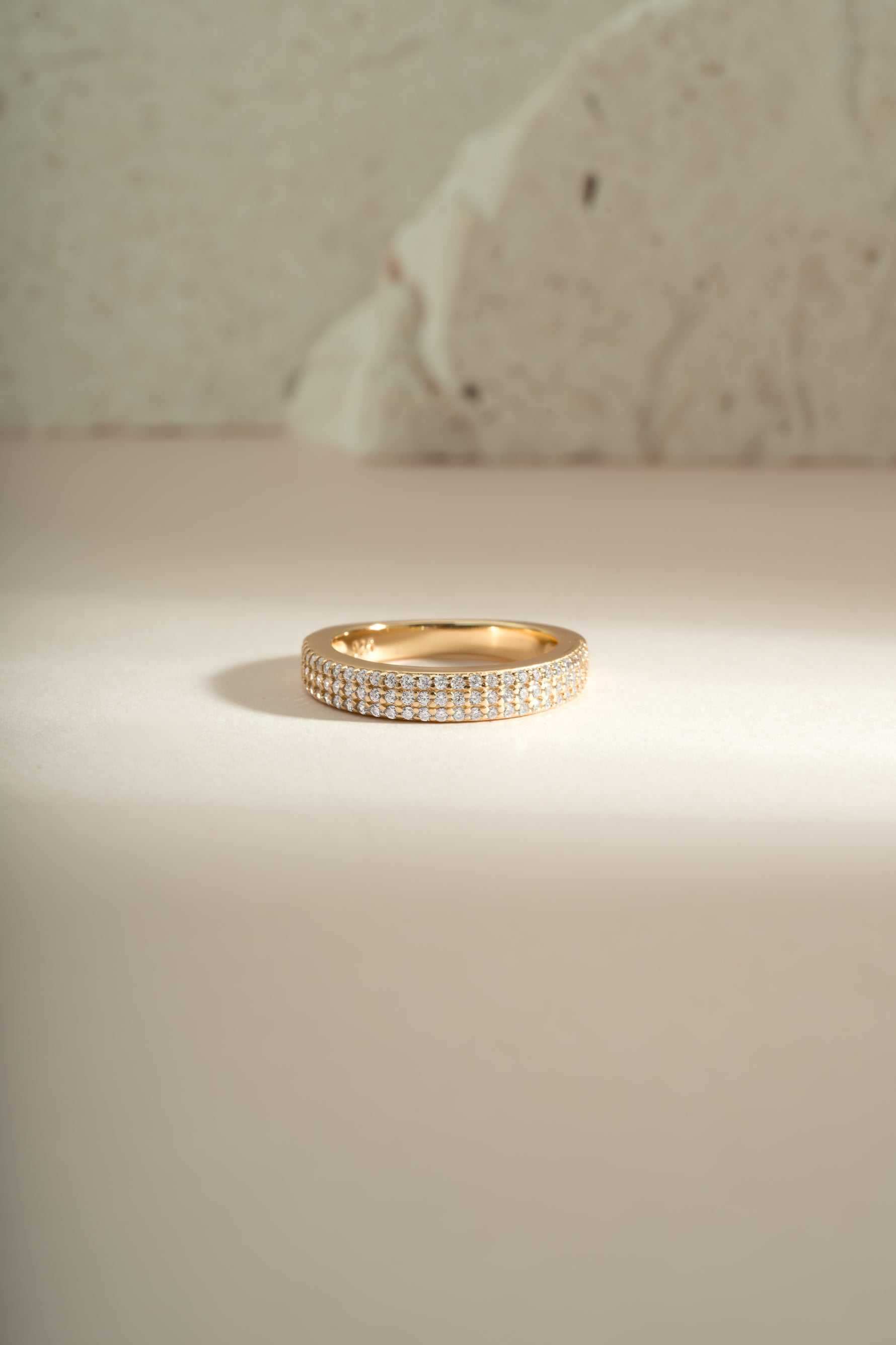 Gold 3-row diamond ring by Sami Jewels showcasing sparkling diamonds and elegant design on a sleek gold band.