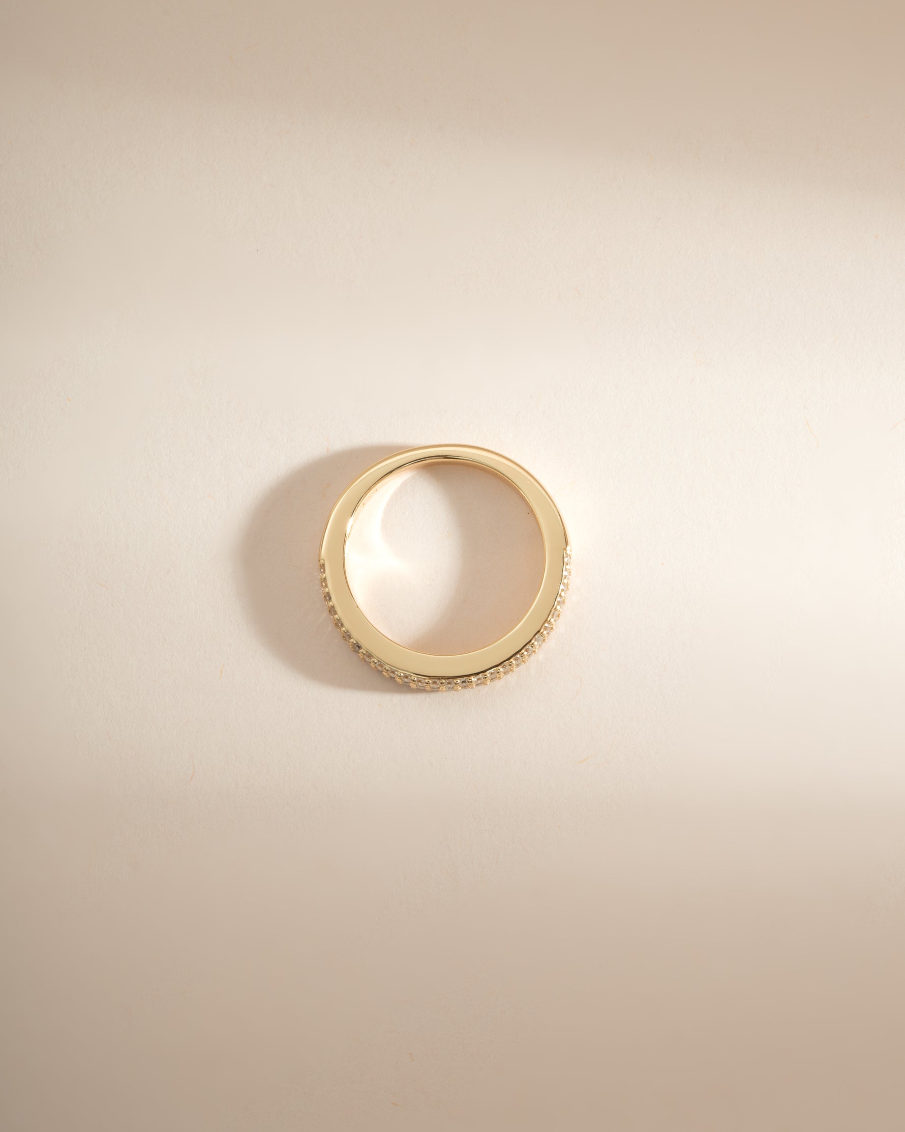 Gold 3-row diamond ring by Sami Jewels, showcasing sparkling diamonds and intricate design from a top view.