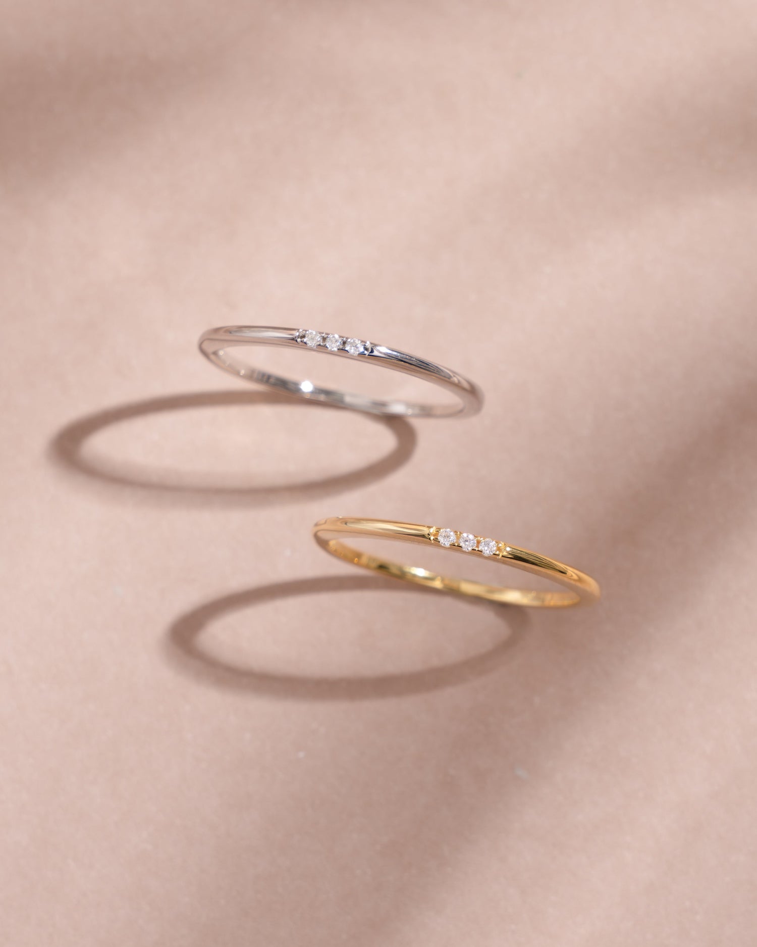 Sterling silver CZ 3-stone ring with gold accents, showcasing sparkling gemstones in a front view design.