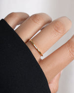 3 stone cubic zirconia stacking ring in gold on model