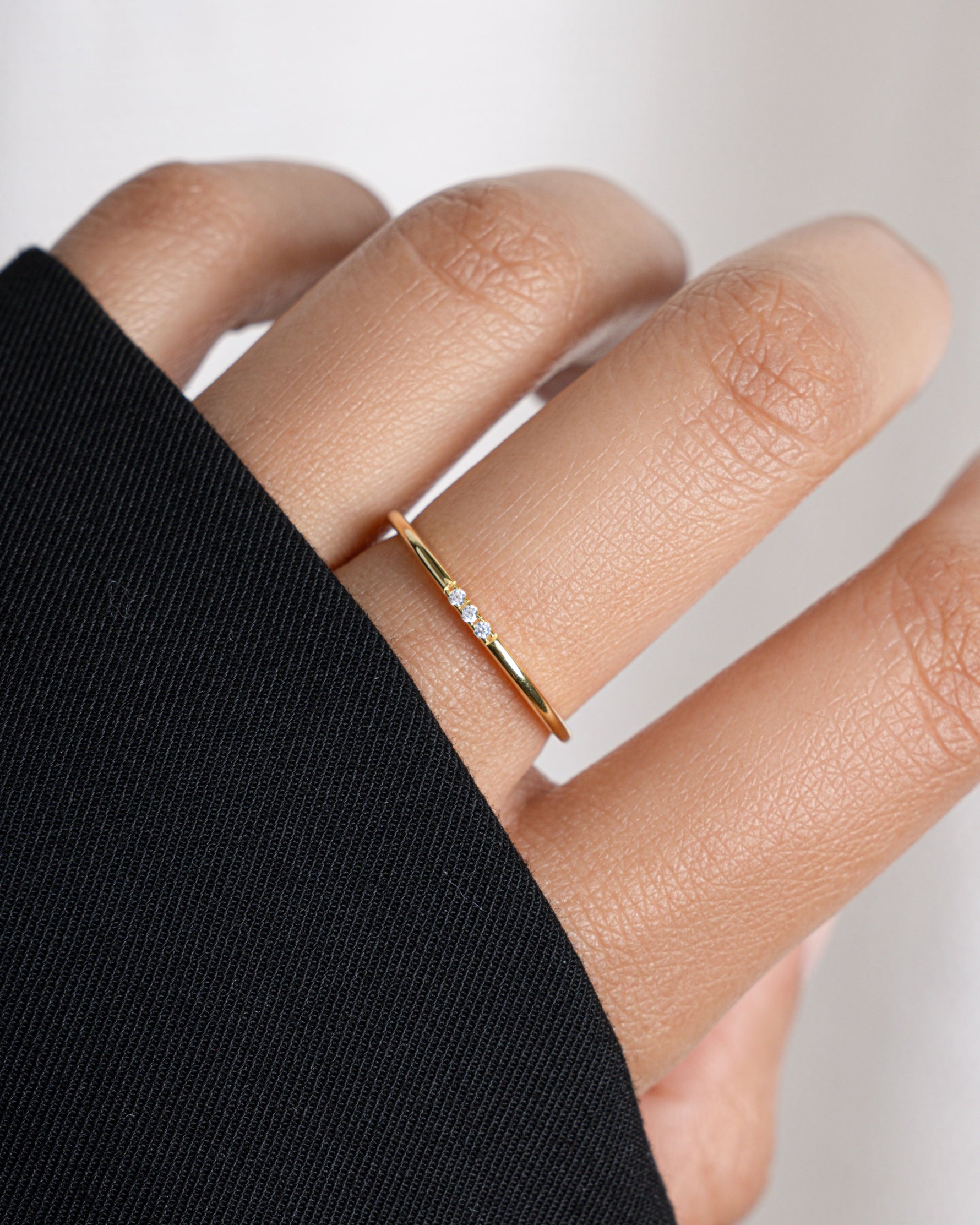 3 stone cubic zirconia stacking ring in gold on model