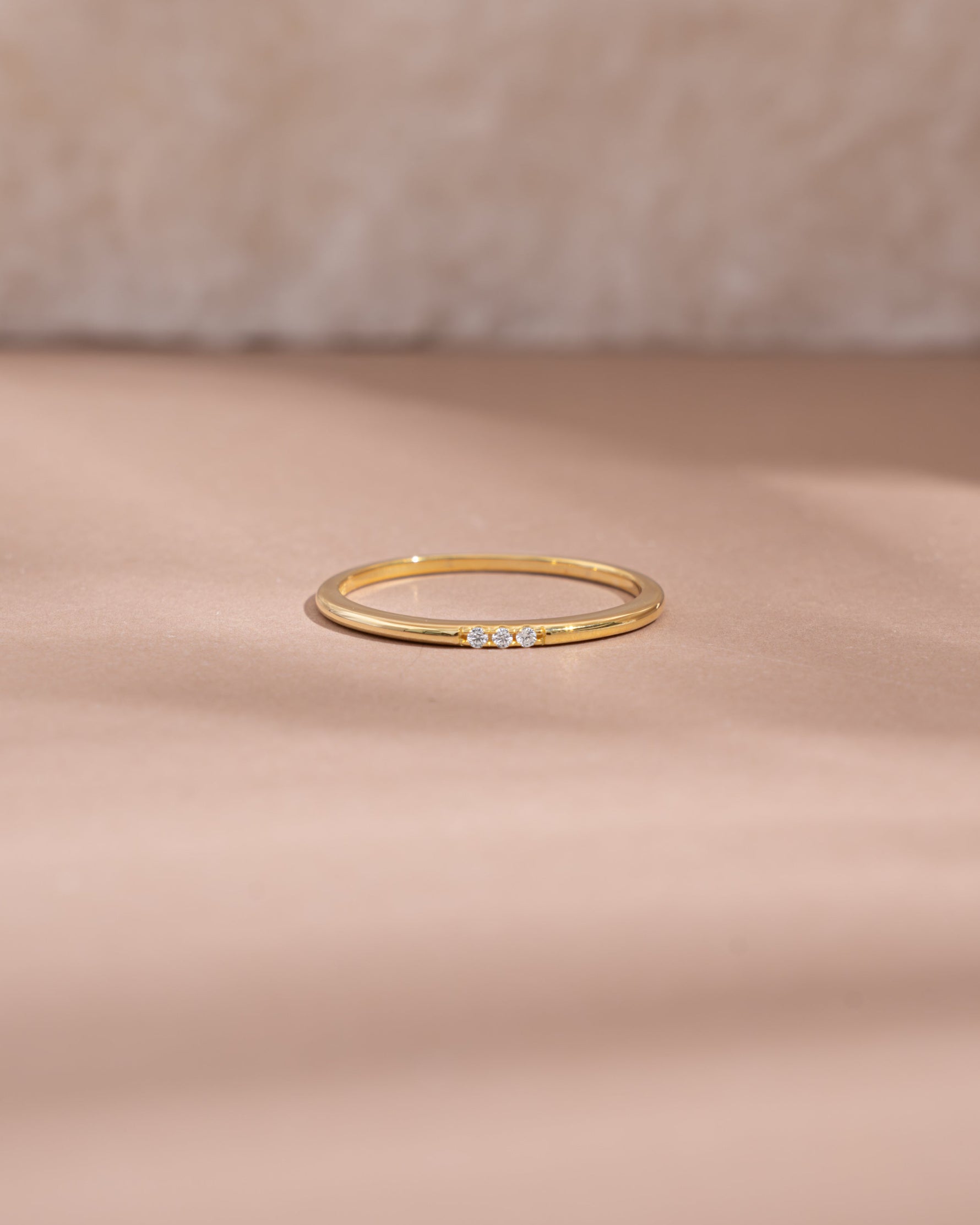 3 stone cubic zirconia stacking ring in gold front view