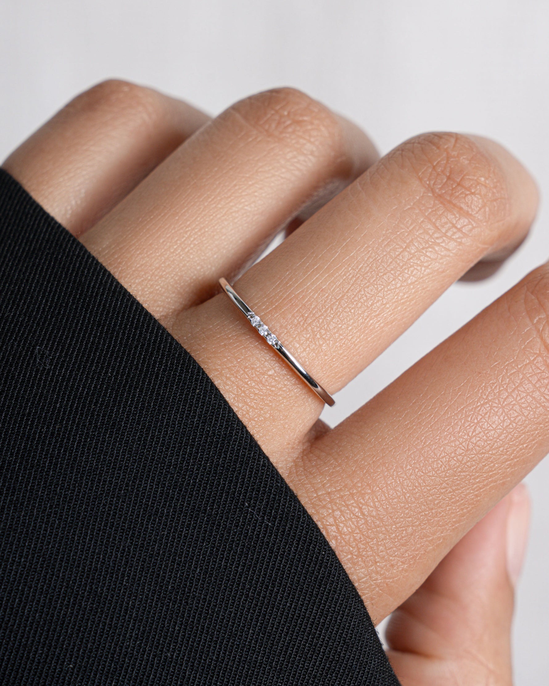 3 stone cubic zirconia stacking ring in sterling silver on model