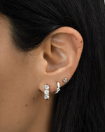 Sterling silver Bella 3 Stone Huggie Hoop Earrings by Sami Jewels, featuring three sparkling stones on small, stylish hoops.