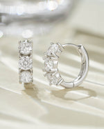 Sterling silver Bella 3 Stone Huggie Hoops earrings featuring three sparkling stones and a secure hoop design.