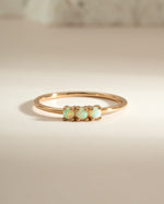 Gold 3-stone opal ring by Sami Jewels featuring vibrant opal gemstones set in elegant gold bands.