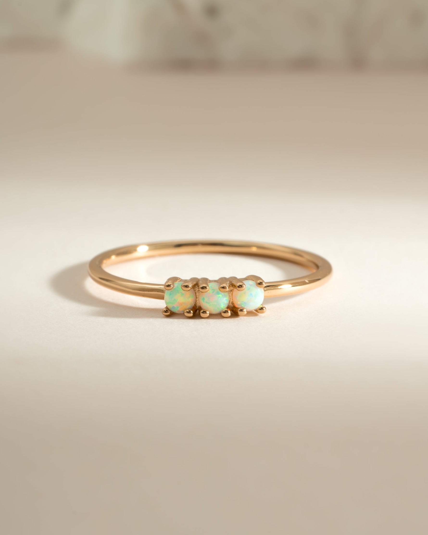 Gold 3-stone opal ring by Sami Jewels featuring vibrant opal gemstones set in elegant gold bands.