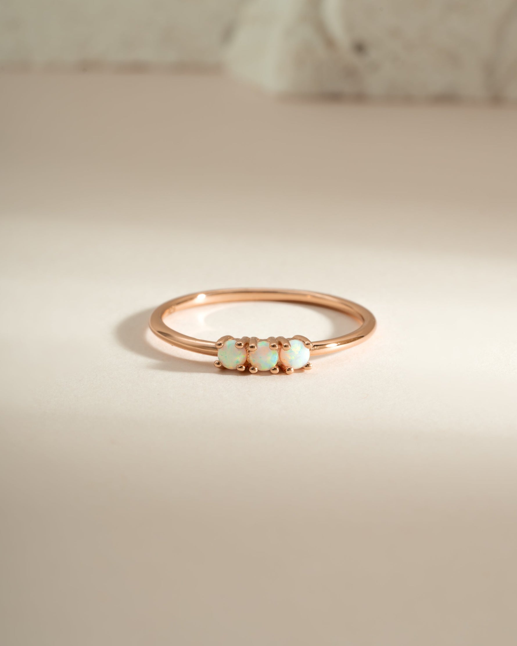 Sami Jewels 3 Stone Opal Ring featuring three vibrant opal gemstones set in a rose gold band.