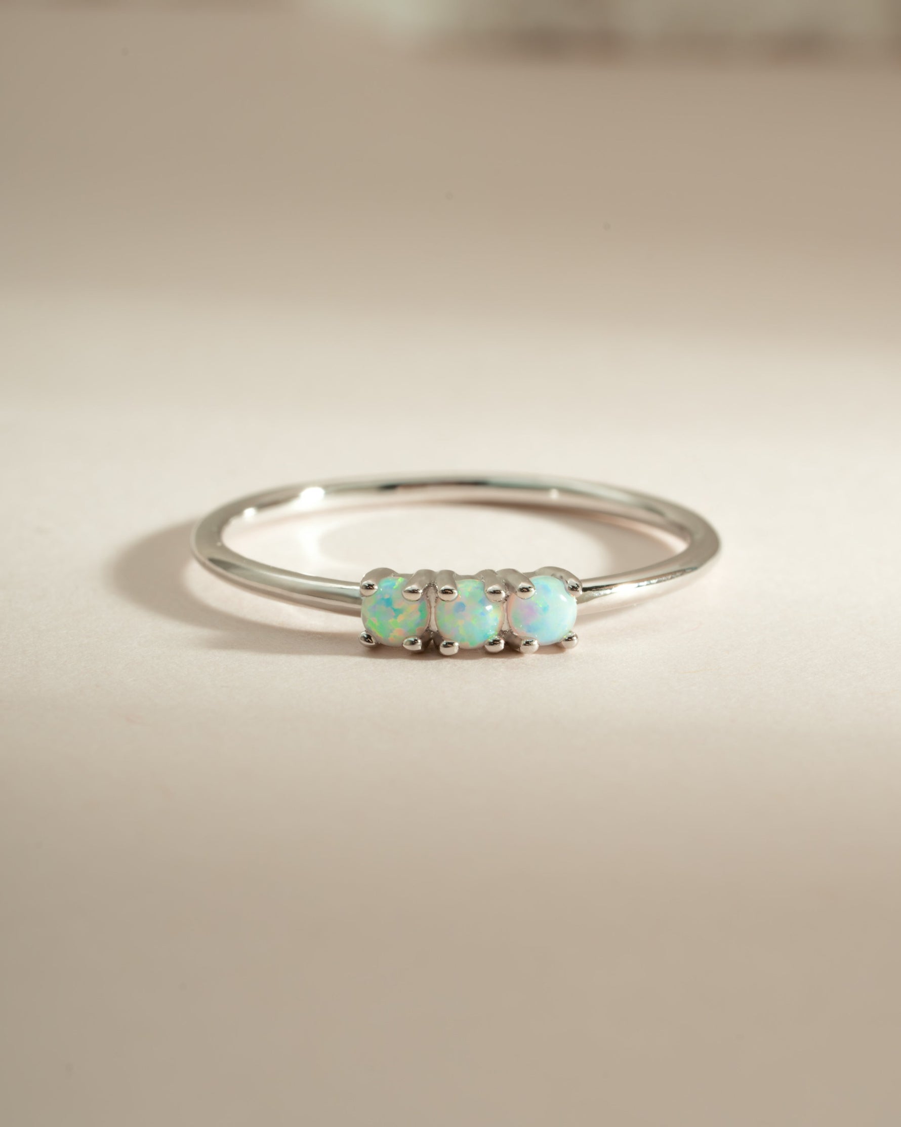 Sterling silver 3-stone opal ring from Sami Jewels showcasing vibrant, colorful opals set in a sleek band.