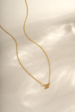 Gold angel number necklace from Sami Jewels featuring the number 333 on a delicate chain.
