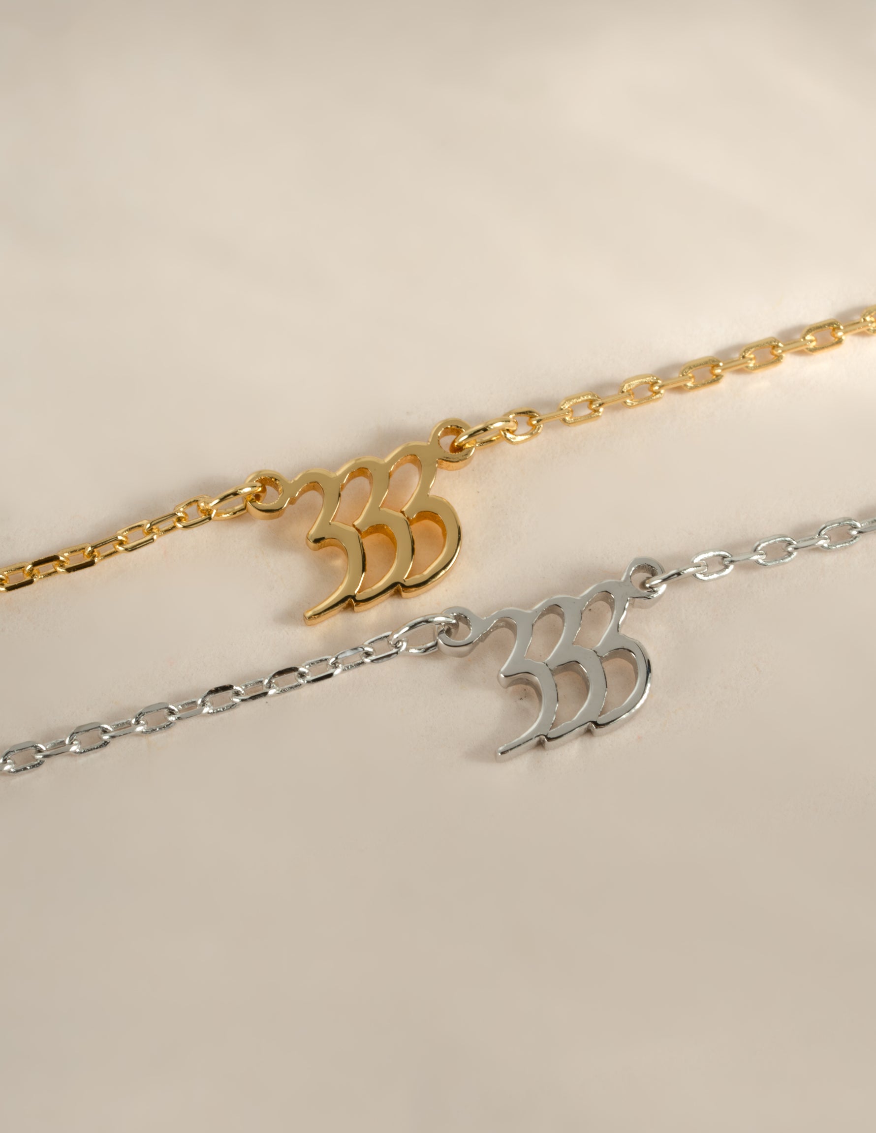 Sterling silver and gold angel number 333 necklace from Sami Jewels, featuring a sleek, modern design on a delicate chain.