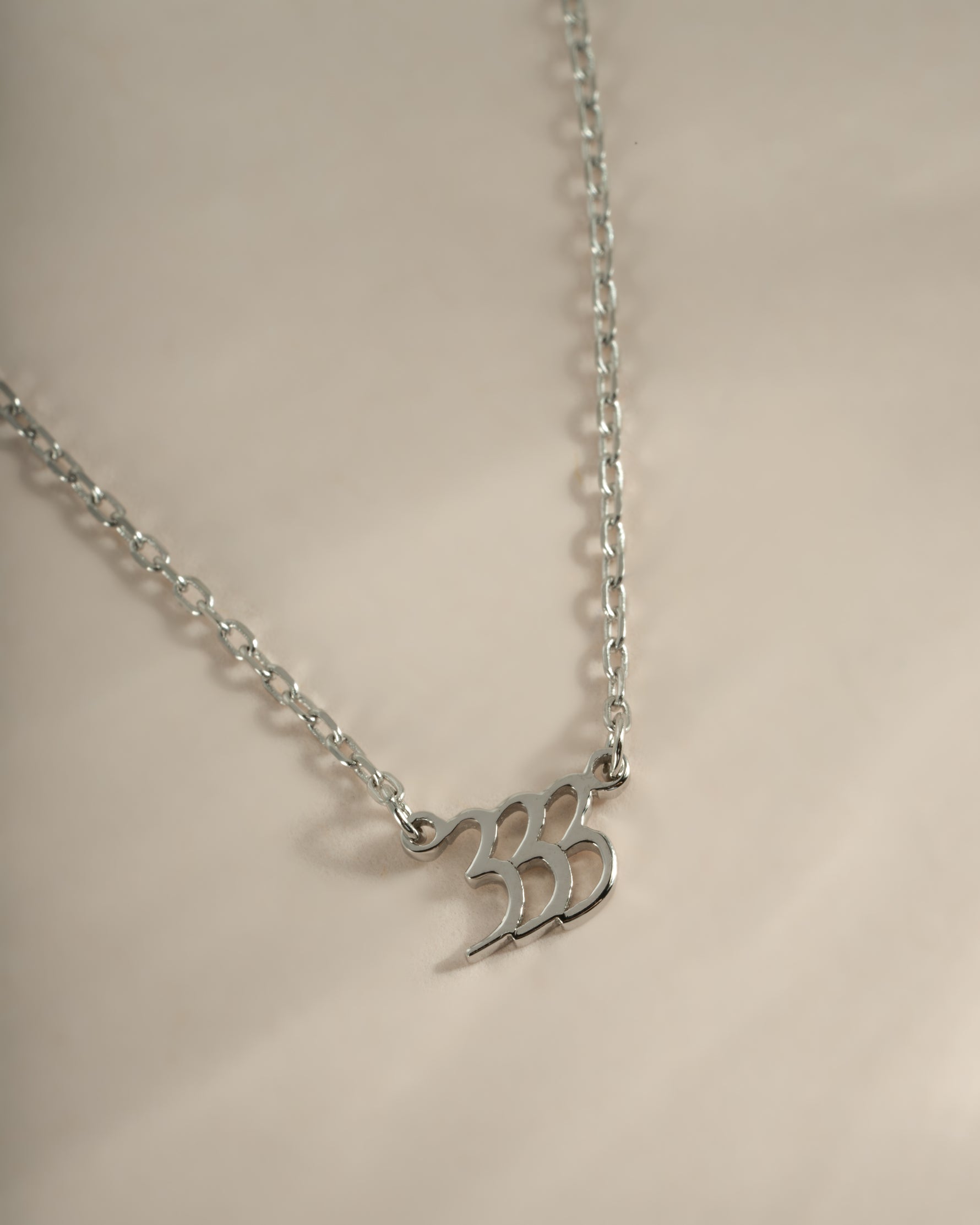 Close-up of Sami Jewels sterling silver Angel Number 333 necklace showing the detailed pendant design.