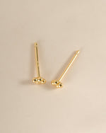 Gold 4-ball stud earrings by Sami Jewels, top view showing small round ball designs on each earring.