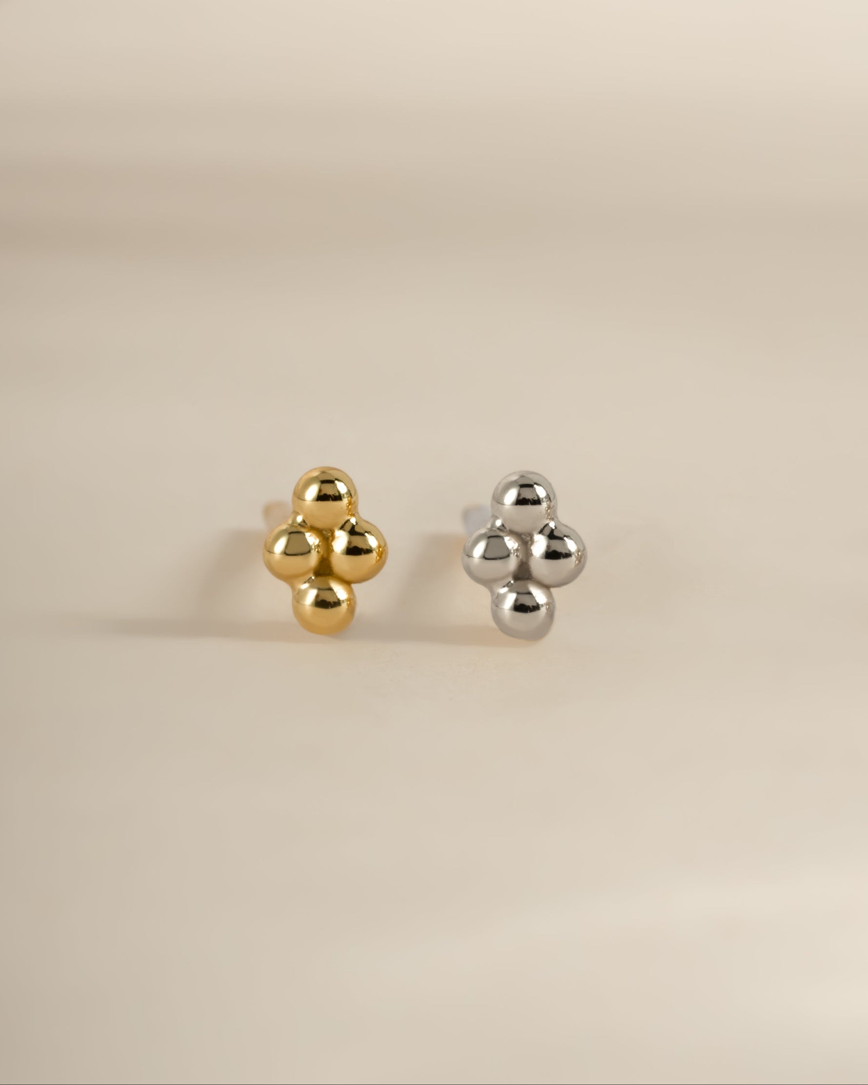 Gold and sterling silver 4-ball stud earrings by Sami Jewels, featuring minimalist round ball design on earlobes.