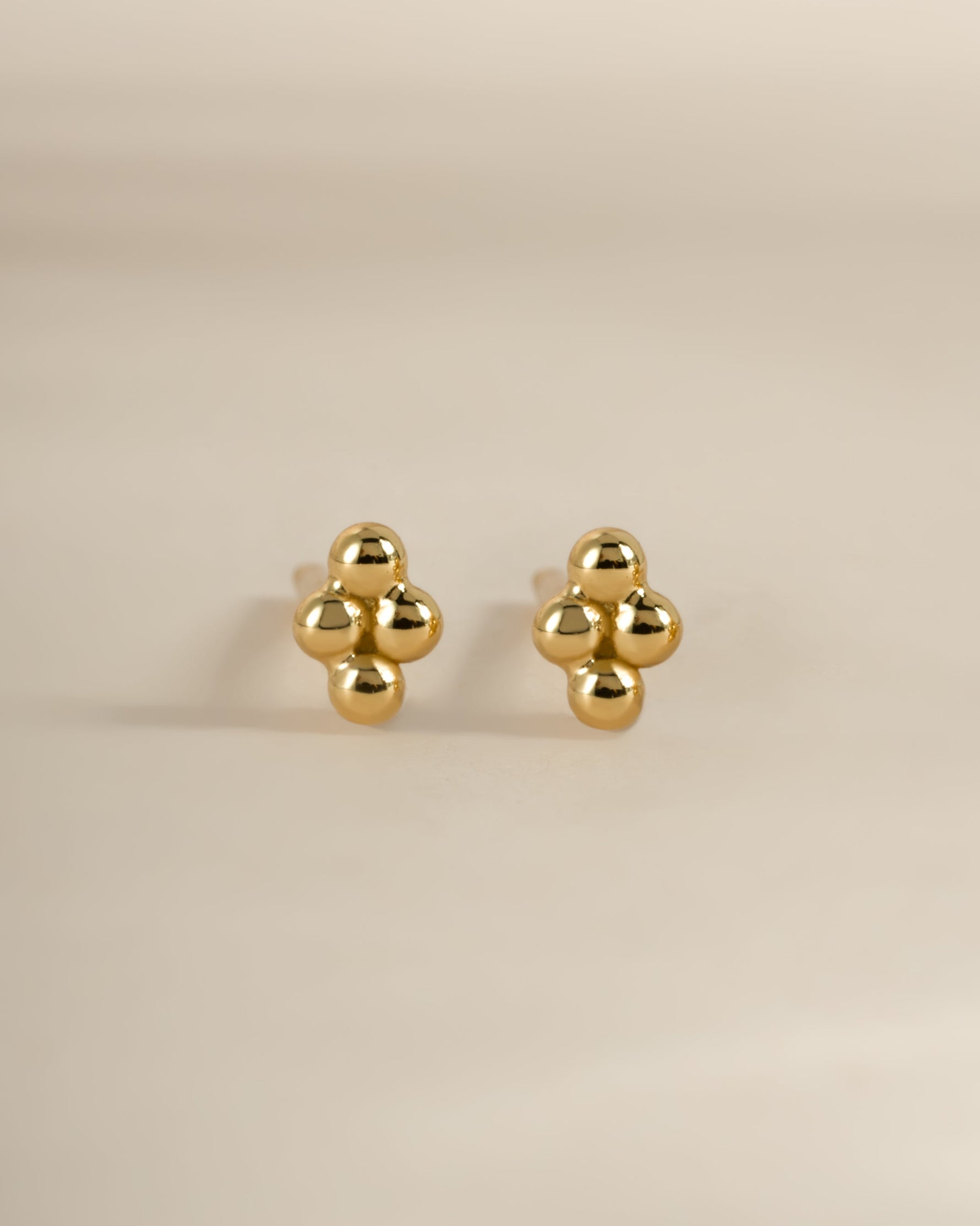 Gold 4-ball stud earrings by Sami Jewels, front view showing shiny spherical design on each earring.