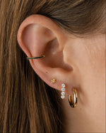 Gold 4-ball stud earrings by Sami Jewels styled on a model, showcasing simple and elegant jewelry design.