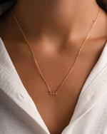 Gold angel number 444 necklace by Sami Jewels, featuring a delicate chain and engraved angel number pendant.