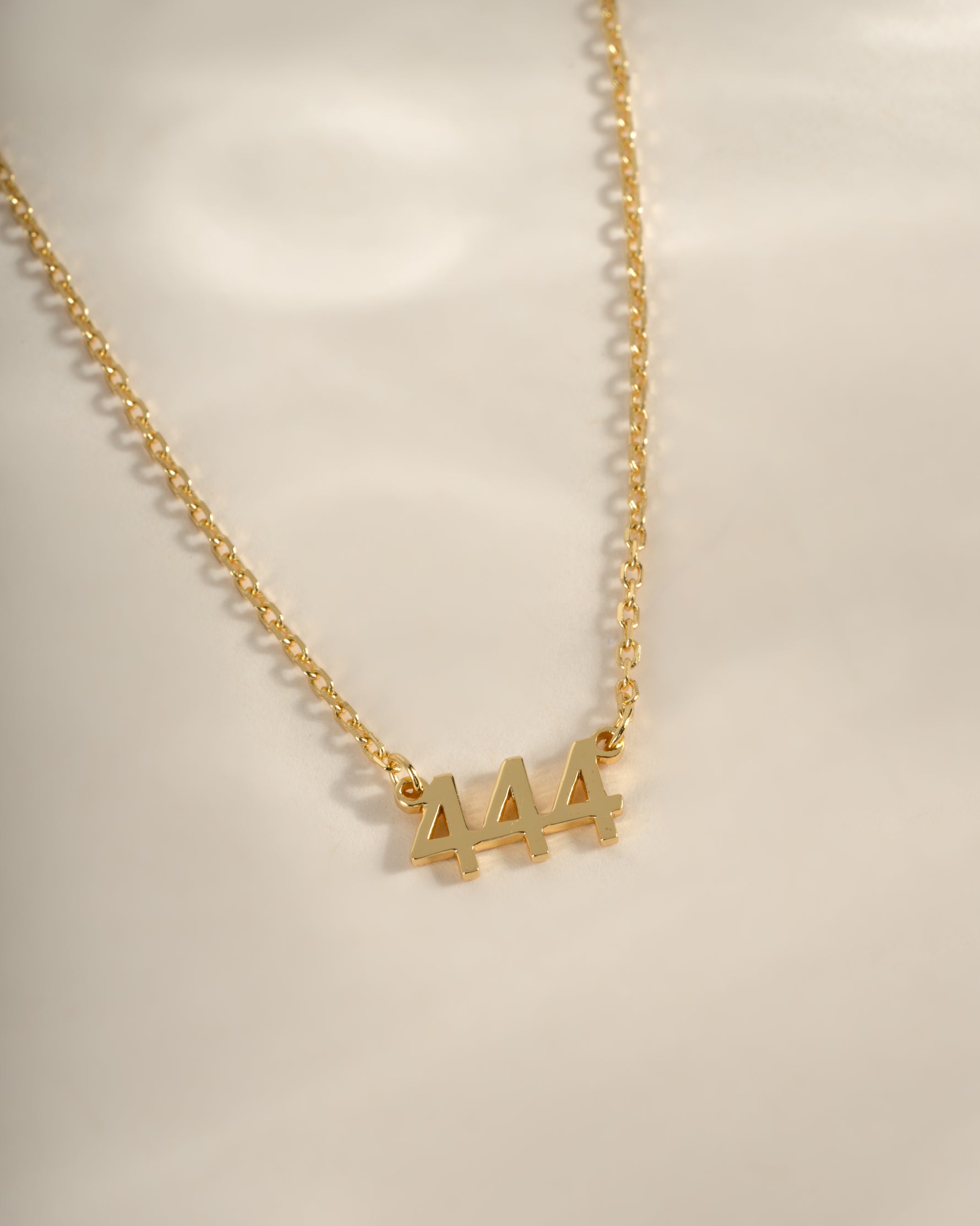 Gold angel number 444 necklace by Sami Jewels featuring a delicate pendant with the number 444, designed for elegant everyday wear.