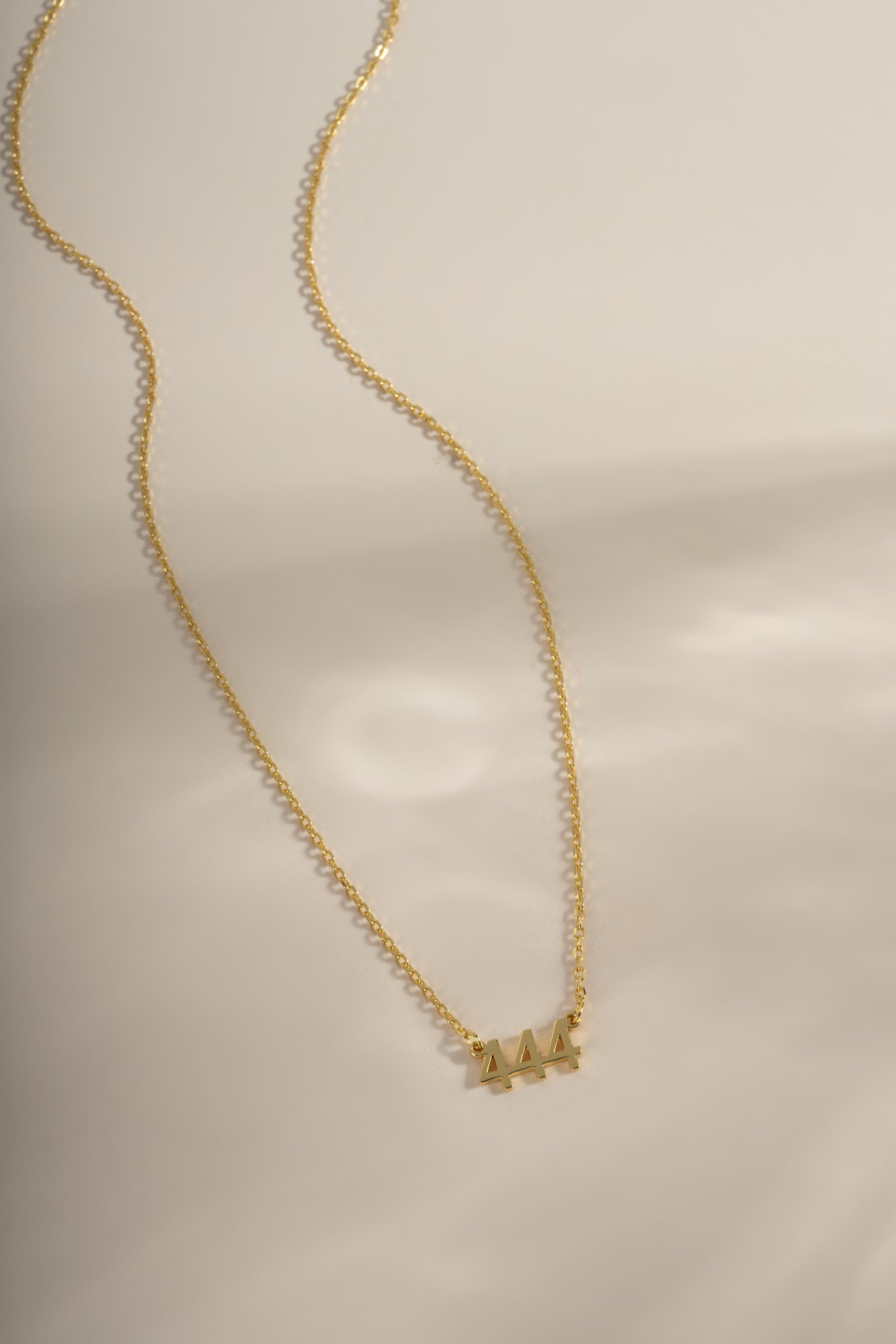 Gold Sami Jewels Angel Number Necklace with 444 pendant, featuring a delicate chain and stylish design.