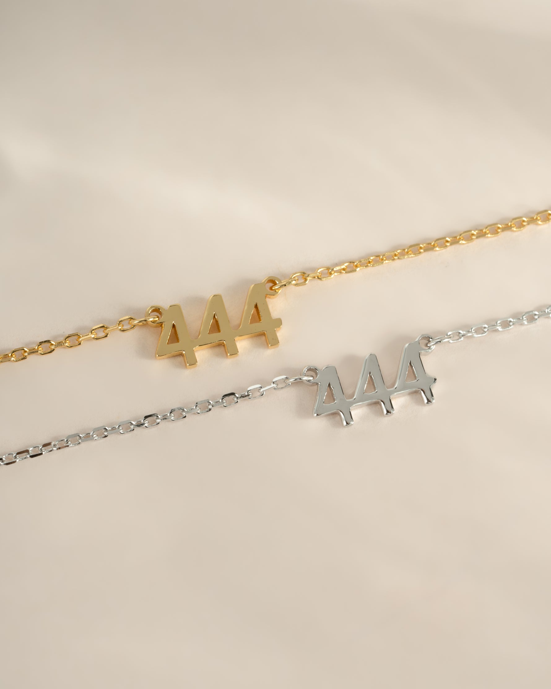 Sterling silver and gold angel number 444 necklace by Sami Jewels, showcasing a delicate pendant design.