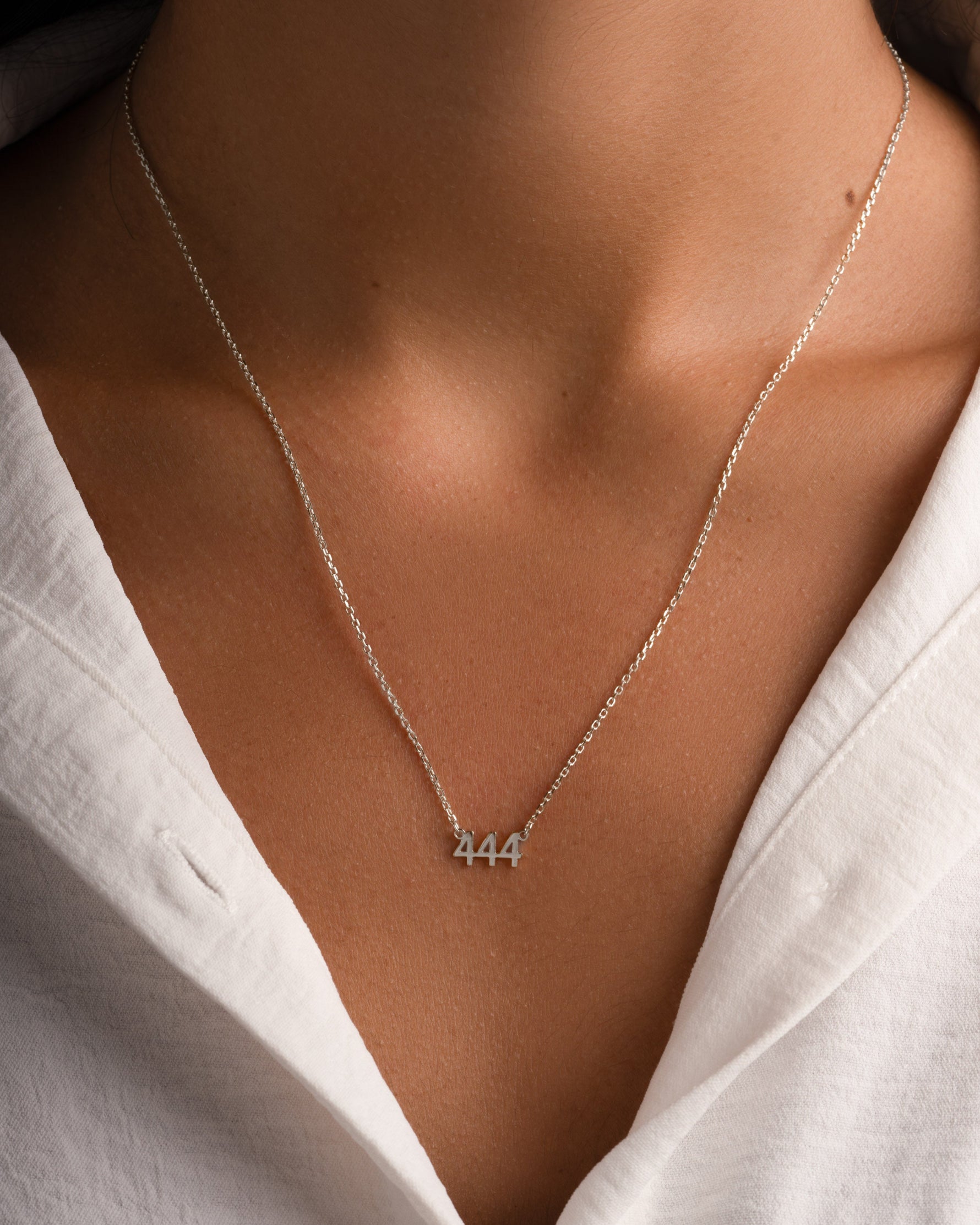 Sterling silver angel number 444 necklace by Sami Jewels, featuring a delicate pendant on a chain.
