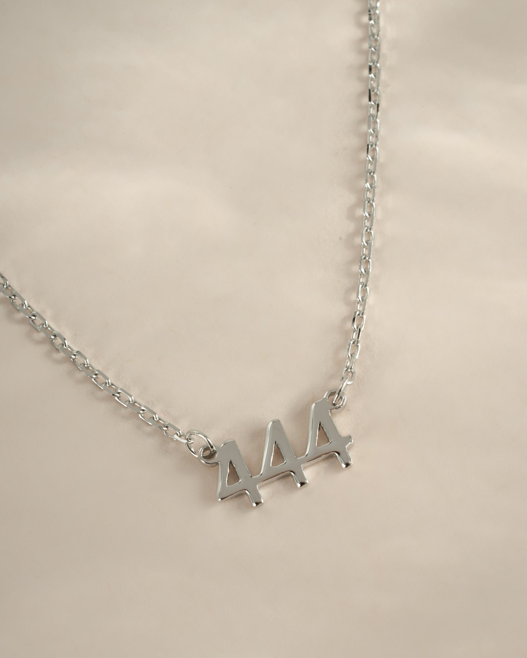 Sterling silver Angel Number 444 necklace by Sami Jewels featuring a pendant with angel number design on a delicate chain.