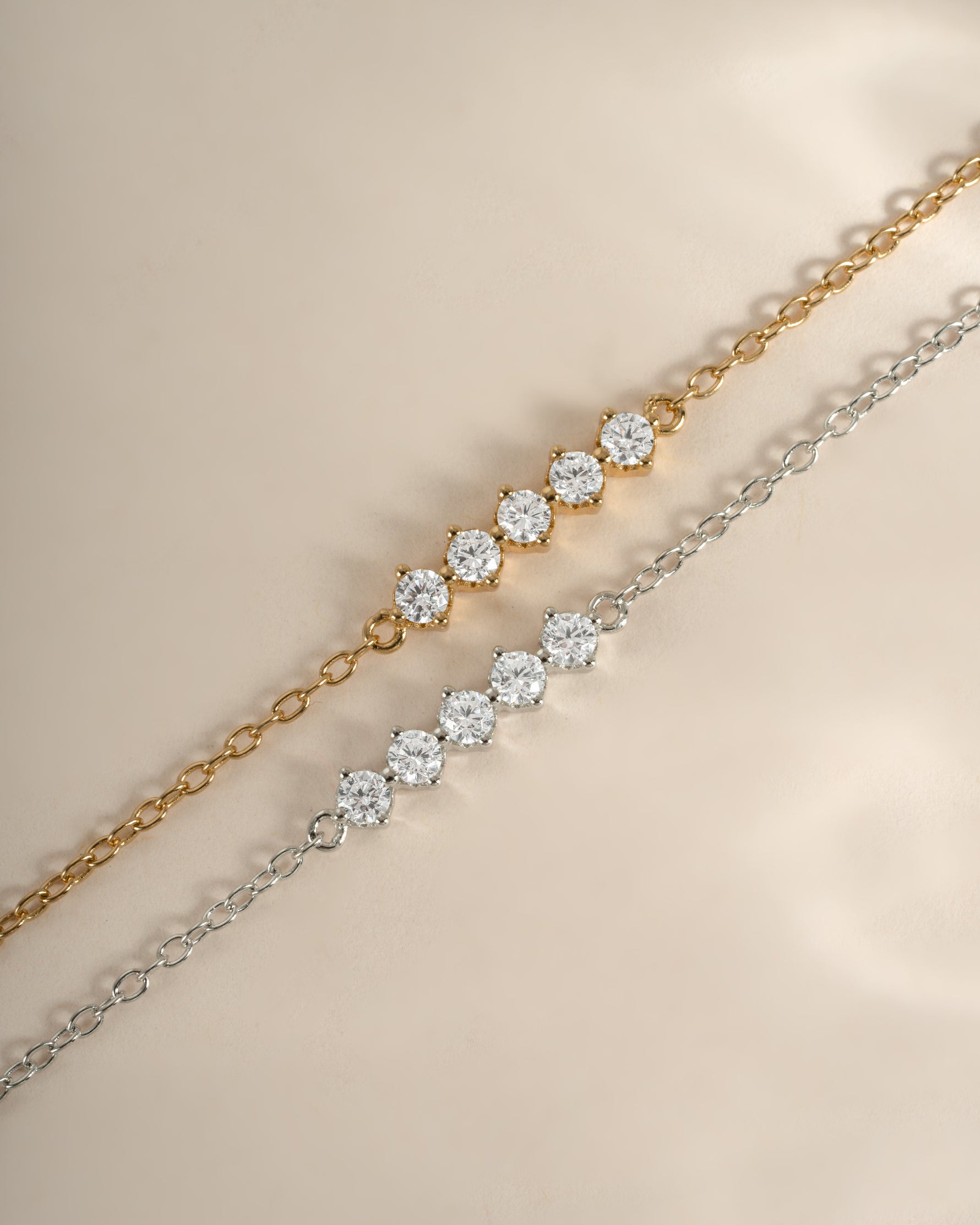 Sterling silver bracelet featuring five sparkling diamond stones, crafted by Sami Jewels with a sleek gold-tone finish.