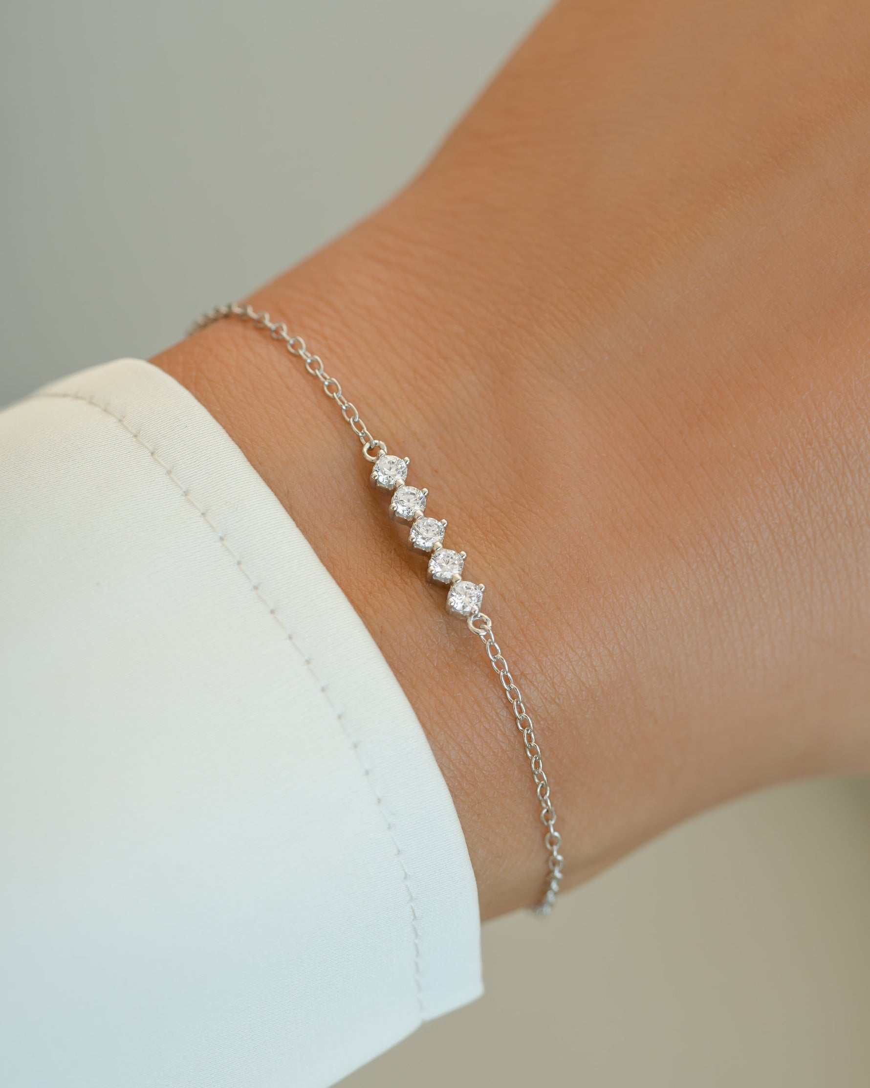 Sterling silver 5-stone diamond bracelet by Sami Jewels featuring sparkling diamonds and elegant design.