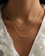 Gold Five Stone Bar Necklace by Sami Jewels styled on a model, featuring five sparkling diamond stones on a delicate gold chain.