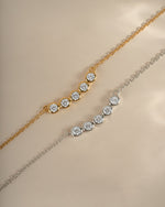 Sterling silver and gold five-stone diamond necklace by Sami Jewels, showcasing elegant row of sparkling gemstones on a delicate chain.