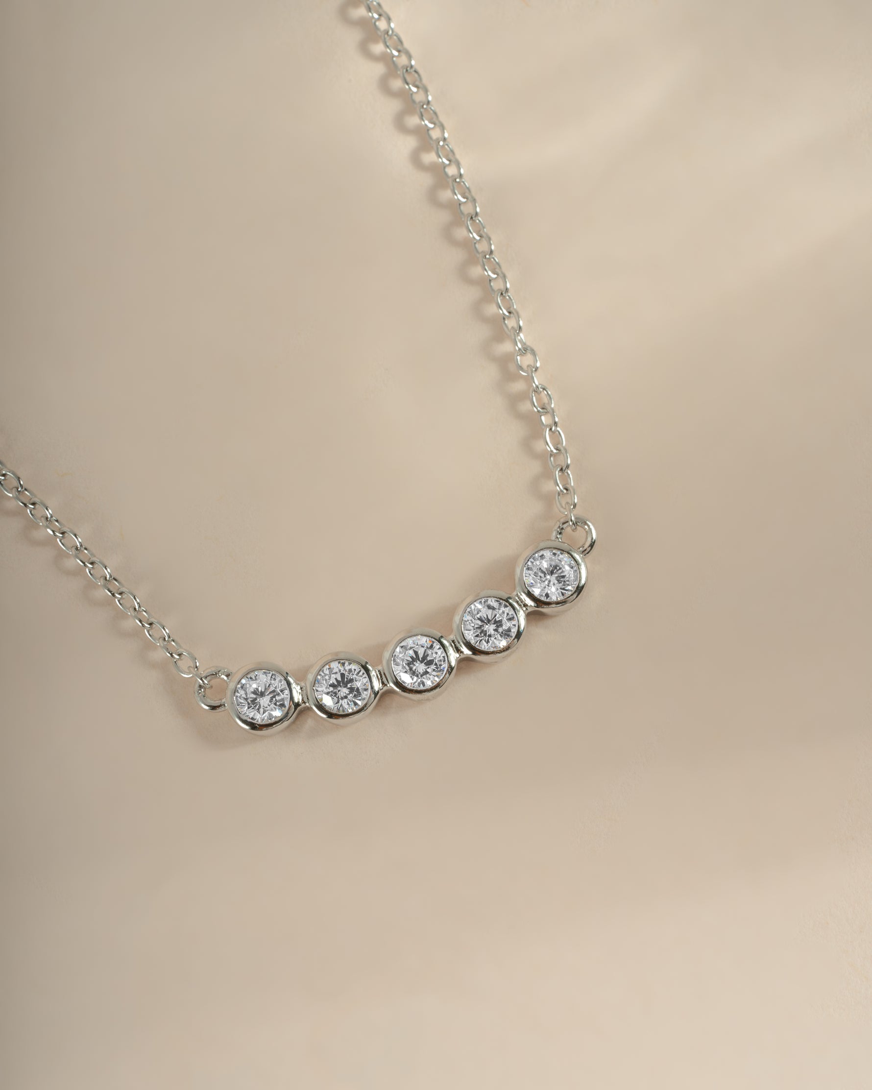 Close-up of Sami Jewels Five Stone Bar Necklace featuring five sparkling diamonds on a sleek sterling silver chain.