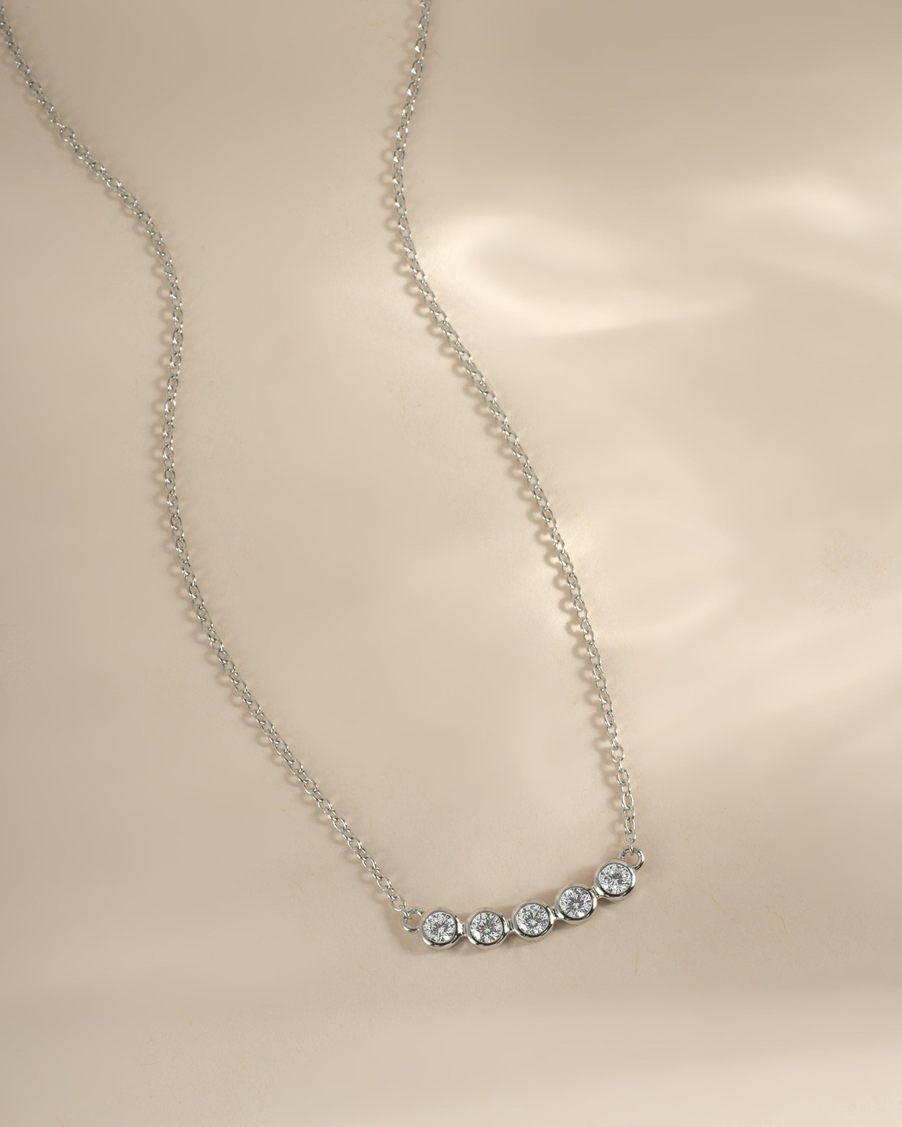 Sterling silver Five Stone Bar Necklace with five small diamond accents, designed by Sami Jewels.
