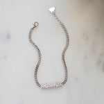 Closeup image of sterling silver bracelet with cuban link chain and a MAMA charm