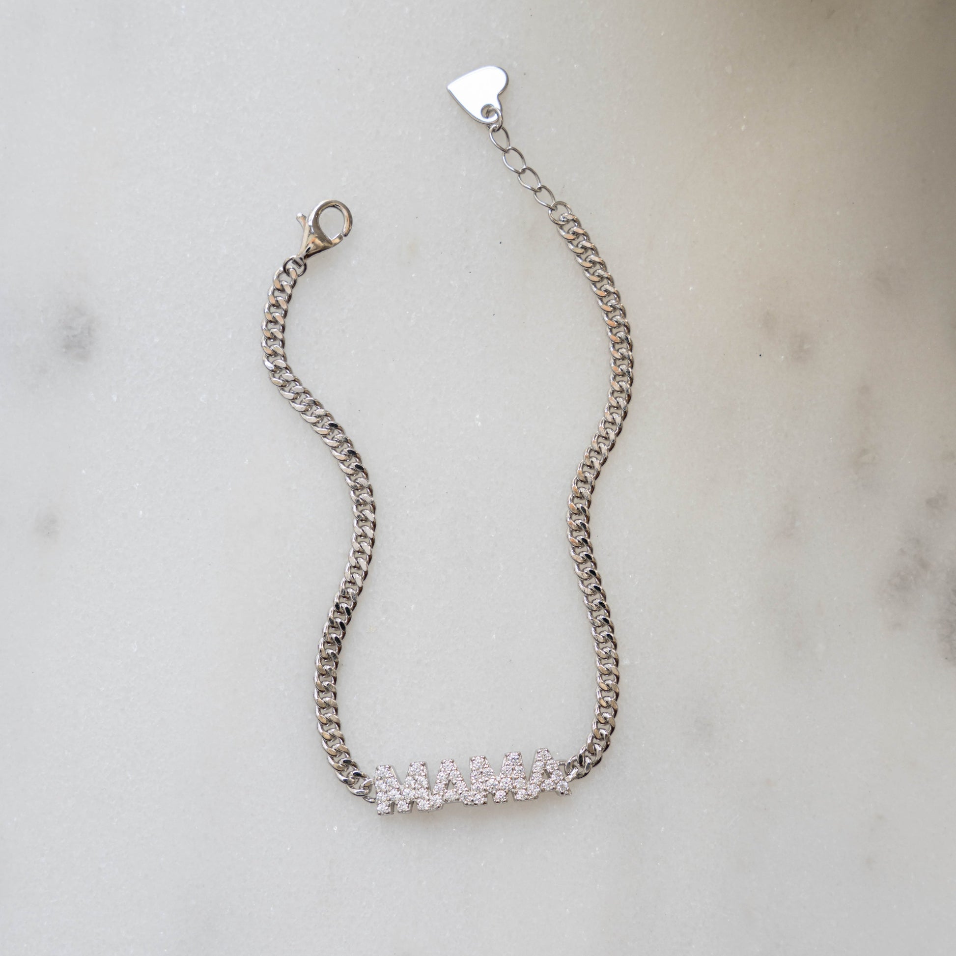 Closeup image of sterling silver bracelet with cuban link chain and a MAMA charm