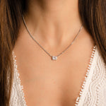 Sterling silver Halo emerald cut necklace on Cuban chain, modeled for chic and sophisticated style