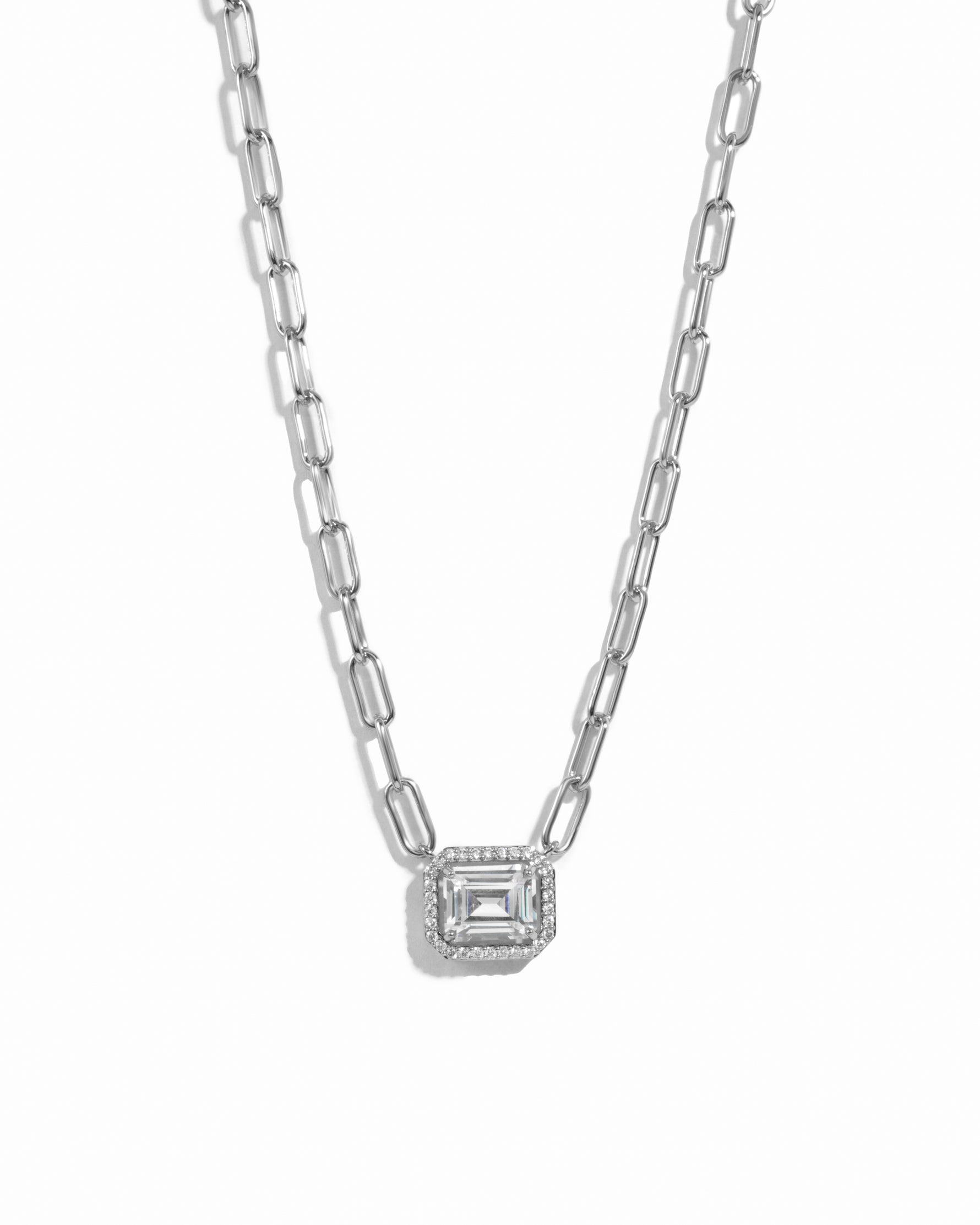 Silver paperclip  necklace with a square pendant on a white background