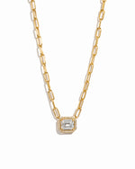 Gold paperclip chain necklace with a diamond pendant on a white background