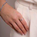 Model wearing minimalist ring featuring dainty pearl gemstone
