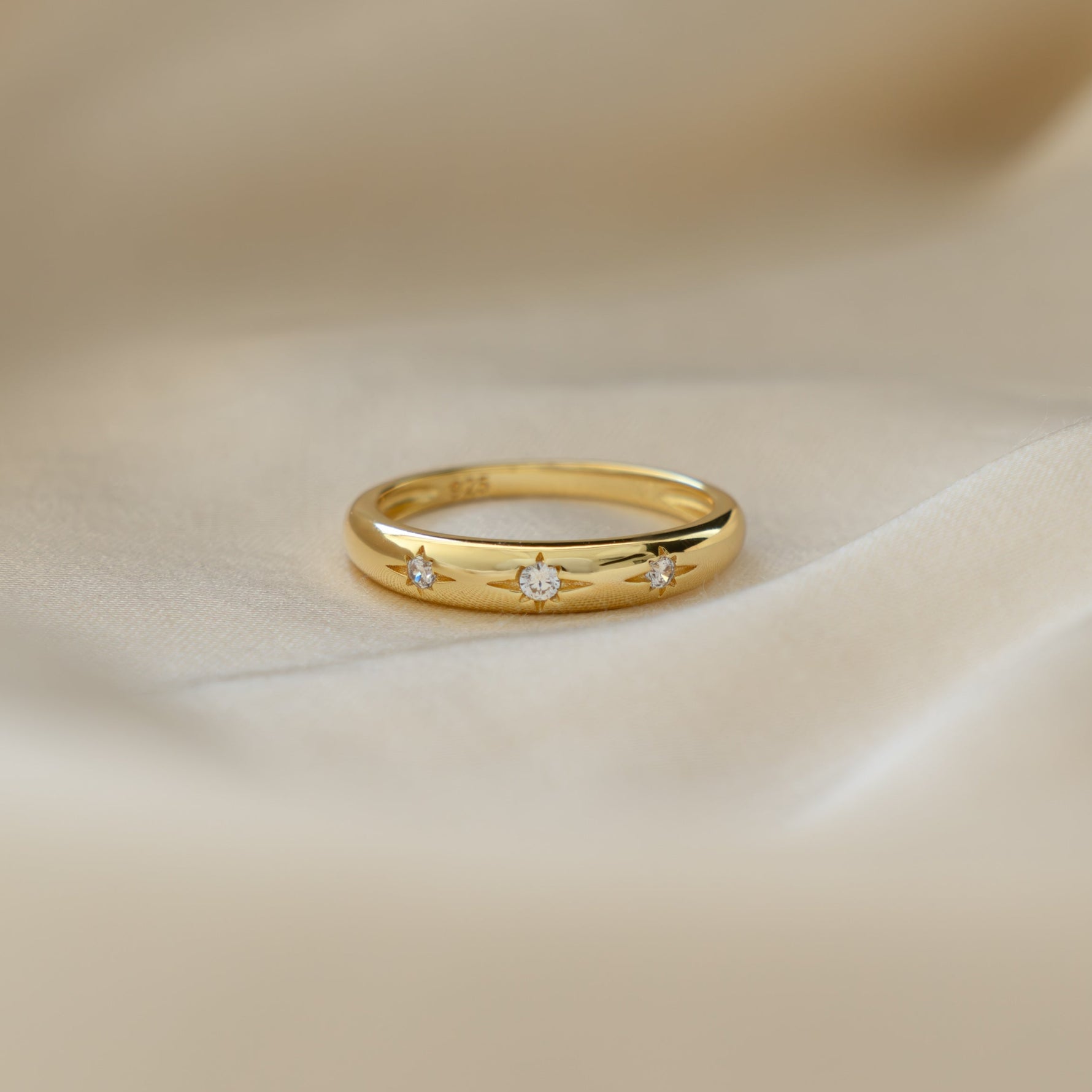 Minimalist Dome Star Setting Diamond Ring on Silk background