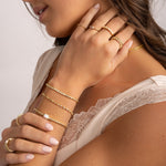 model wearing gold dainty gold jewelry