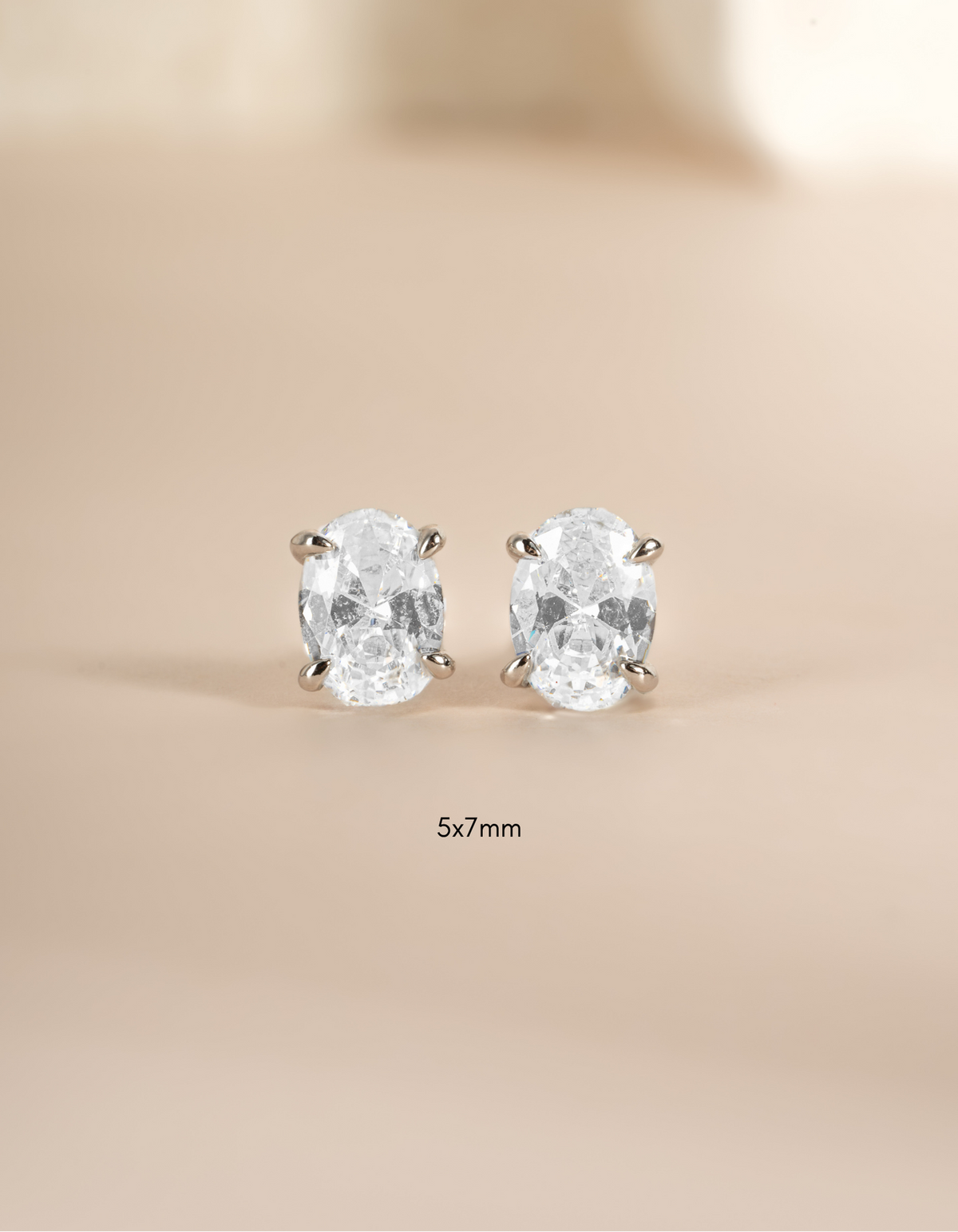 Sterling silver 5x7mm oval stud earrings by Sami Jewels featuring classic, elegant oval-shaped design.